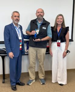 Dr. Caleb Marsh accepting the award at the ceremony