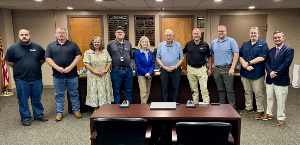 Photo of Wilkes Community College staff along with the Wilkes COunty Commissioners in he county office